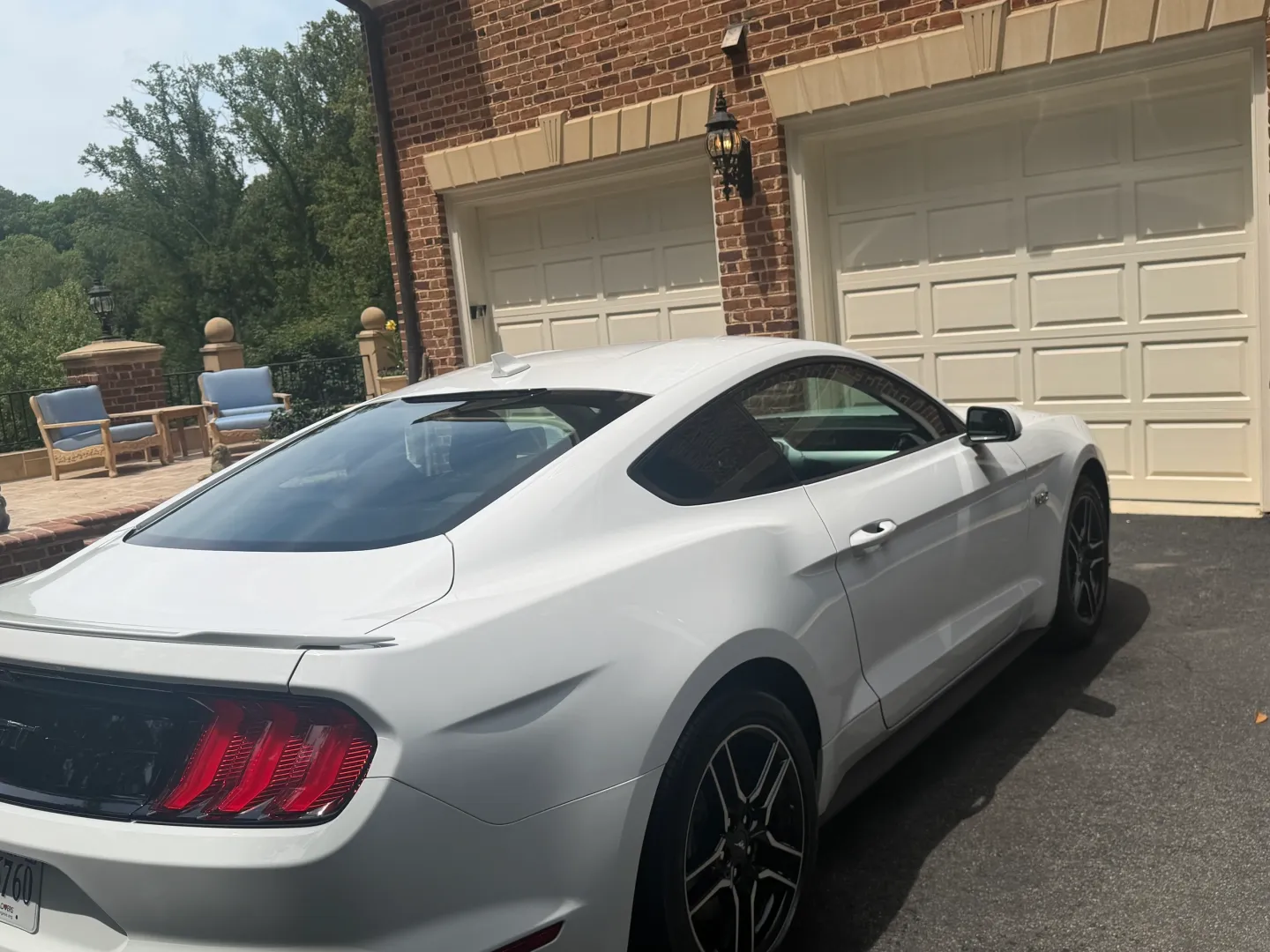 White Ford Mustang parked in driveway