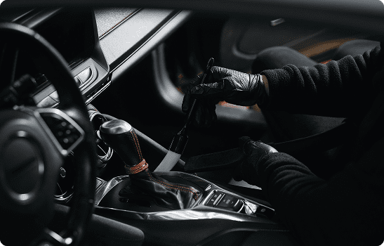 Gloved hands shifting gear inside modern car