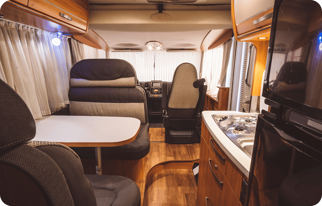 Cozy RV interior with dining area and kitchenette