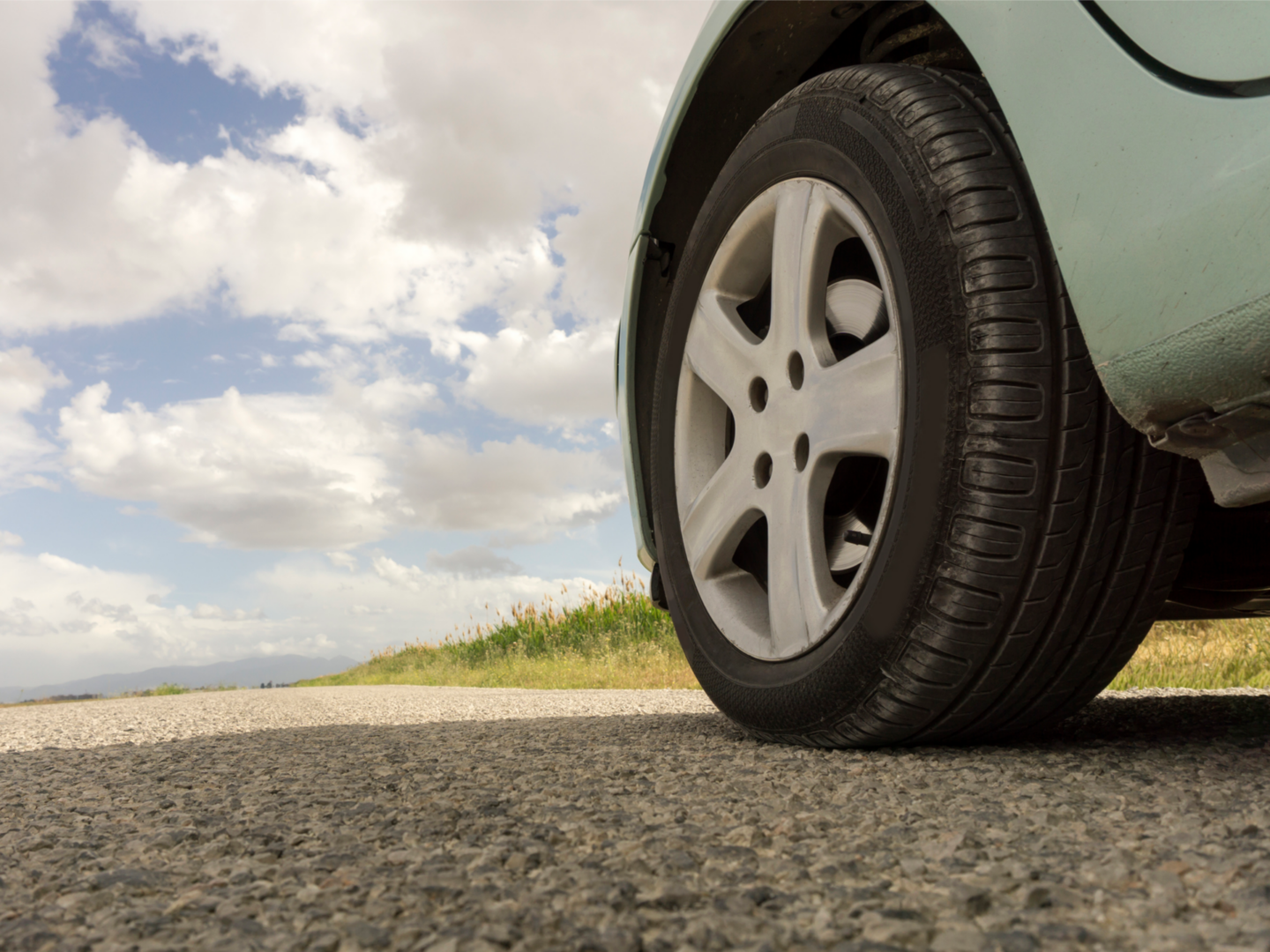 Low-angle car tire on country road